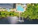 Aerial view of a resort-style pool with lake access, sun loungers and well manicured landscaping at 13427 Blue Heron Beach Dr # 2106, Orlando, FL 32821