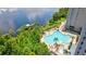 Stunning aerial view of the lake, swimming pool, fishing dock and lounge area from the Condo at 13427 Blue Heron Beach Dr # 2106, Orlando, FL 32821