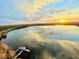 Stunning sunset over the lake with a view of the dock, and the city skyline in the distance at 13427 Blue Heron Beach Dr # 2106, Orlando, FL 32821