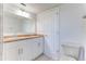Well-lit bathroom with a white vanity, wood countertop, and a large mirror above the sink at 2735 N Poinciana Blvd # 103, Kissimmee, FL 34746