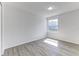 Sunlit bedroom featuring wood-look floors, a large window, and neutral decor at 2735 N Poinciana Blvd # 103, Kissimmee, FL 34746