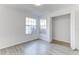 Bright bedroom featuring gray floors, two windows, and a closet at 2735 N Poinciana Blvd # 103, Kissimmee, FL 34746