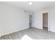 Well-lit bedroom with wood-look flooring, featuring a white wall, and easy access to other rooms at 2735 N Poinciana Blvd # 103, Kissimmee, FL 34746
