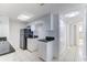 Kitchen showcasing white cabinets, black appliances, and access to the living area at 2735 N Poinciana Blvd # 103, Kissimmee, FL 34746