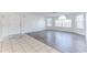 Open-concept living room with tile and wood flooring and a front door for easy access at 2735 N Poinciana Blvd # 103, Kissimmee, FL 34746
