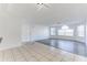 Inviting living room with modern lighting, tile and wood flooring and a view of the windowed exterior at 2735 N Poinciana Blvd # 103, Kissimmee, FL 34746