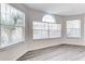 Bright living area with a bay of large windows featuring blinds and wood flooring at 2735 N Poinciana Blvd # 103, Kissimmee, FL 34746
