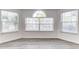Bright living area with a bay of large windows featuring blinds and wood flooring at 2735 N Poinciana Blvd # 103, Kissimmee, FL 34746