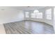 Spacious, light-filled living room featuring wood-look floors and large windows at 2735 N Poinciana Blvd # 103, Kissimmee, FL 34746