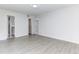 Spacious main bedroom with modern wood-look flooring, access to closets, and an ensuite bathroom at 2735 N Poinciana Blvd # 103, Kissimmee, FL 34746