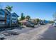 Exterior of the property and parking lot showing multiple parked cars on a sunny day at 2735 N Poinciana Blvd # 103, Kissimmee, FL 34746