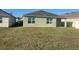 Back exterior of a home with a covered patio and a large backyard at 357 Summershore Dr, Auburndale, FL 33823