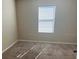 This bedroom has a large window and neutral carpeting at 357 Summershore Dr, Auburndale, FL 33823