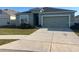 Well-maintained single-story home with a two-car garage and a neatly manicured front lawn at 357 Summershore Dr, Auburndale, FL 33823