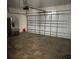 Spacious garage features a full-size refrigerator and ample storage at 357 Summershore Dr, Auburndale, FL 33823