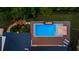 An aerial view of a backyard featuring a pool, fire pit, and outdoor seating area at 1691 Chestnut Ave, Winter Park, FL 32789