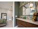 Stylish bathroom with modern vanity, mirror, and unique wallpaper at 1691 Chestnut Ave, Winter Park, FL 32789