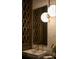 Elegant vanity in modern bathroom with geometric backsplash, stylish lighting and fixtures at 1691 Chestnut Ave, Winter Park, FL 32789