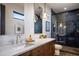 Modern bathroom with sleek fixtures, a glass shower and a marble countertop at 1691 Chestnut Ave, Winter Park, FL 32789