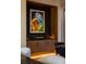 Close-up of the dining room area, showcasing built-in cabinetry, unique wall art, and ambient lighting at 1691 Chestnut Ave, Winter Park, FL 32789