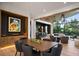 Open-concept dining room features a wooden table, stylish chairs, and seamless flow into the living room and bar area at 1691 Chestnut Ave, Winter Park, FL 32789