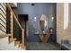 Elegant foyer featuring a modern staircase, console table, and stylish decor at 1691 Chestnut Ave, Winter Park, FL 32789