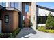 Inviting front entrance featuring a modern wood door, stone accents, and lush landscaping at 1691 Chestnut Ave, Winter Park, FL 32789