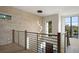 Open hallway showcasing modern lighting and stone wall design at 1691 Chestnut Ave, Winter Park, FL 32789