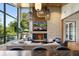Bright living room with large windows, stone fireplace, and modern lighting fixtures at 1691 Chestnut Ave, Winter Park, FL 32789