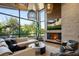 Inviting living room featuring a stone fireplace, large windows, and comfortable seating at 1691 Chestnut Ave, Winter Park, FL 32789