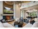 Cozy living room features a brick fireplace, comfortable seating, and a view of the dining area at 1691 Chestnut Ave, Winter Park, FL 32789