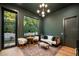 Cozy living room with large window, stylish seating, and a hardwood floor at 1691 Chestnut Ave, Winter Park, FL 32789