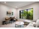 Bright home office with large window, desk, and comfortable seating area at 1691 Chestnut Ave, Winter Park, FL 32789