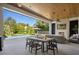 Covered patio featuring dining and lounging areas with fireplace and pool views at 1691 Chestnut Ave, Winter Park, FL 32789