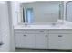 Bathroom features double vanity with white cabinets and modern fixtures, offering ample space at 3842 Knotty Pine St, St Cloud, FL 34772