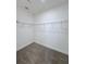 Walk-in closet with shelving, providing ample storage space for clothing and accessories at 3842 Knotty Pine St, St Cloud, FL 34772