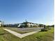 A wide view of a new development community featuring sidewalks, manicured lawns, and inviting townhomes at 3842 Knotty Pine St, St Cloud, FL 34772