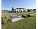 Community streetscape showing sidewalks, park benches, landscaping, and an overview of the well-maintained townhomes at 3842 Knotty Pine St, St Cloud, FL 34772