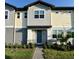 Attractive two-story townhome with neutral-colored siding, tidy landscaping, and a welcoming front entrance at 3842 Knotty Pine St, St Cloud, FL 34772