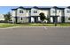 A row of townhomes with tidy landscaping, sidewalks, and well-maintained facades offer an inviting curb appeal at 3842 Knotty Pine St, St Cloud, FL 34772