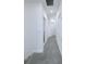 Hallway with gray carpet, leading to other rooms in the home, features neutral paint at 3842 Knotty Pine St, St Cloud, FL 34772
