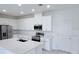 Bright, open-concept kitchen with white cabinets, modern appliances, and a large island for meal preparation at 3842 Knotty Pine St, St Cloud, FL 34772