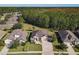 Beautiful aerial view of a single-Gathering home with a manicured lawn, long driveway, and mature trees in a neighborhood at 584 Aldenham Ln, Ormond Beach, FL 32174