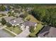 An aerial shot showing a home with a well-kept lawn that backs up to a wooded area at 584 Aldenham Ln, Ormond Beach, FL 32174