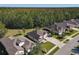 Aerial view of a single-Gathering home backing up to a wooded area in a suburban neighborhood at 584 Aldenham Ln, Ormond Beach, FL 32174