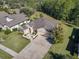 An aerial view of a charming single-story home featuring a manicured lawn and mature landscaping at 584 Aldenham Ln, Ormond Beach, FL 32174