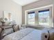 Neutral bedroom featuring decorative accents, big windows, and neutral carpet at 584 Aldenham Ln, Ormond Beach, FL 32174