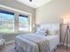 Bright bedroom with white furniture, large windows, and natural light at 584 Aldenham Ln, Ormond Beach, FL 32174