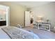 Neutral bedroom with doorway view of bath and kitchen, decorative furniture and carpet at 584 Aldenham Ln, Ormond Beach, FL 32174
