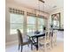 Bright dining room with large windows, a modern chandelier, and stylish decor at 584 Aldenham Ln, Ormond Beach, FL 32174